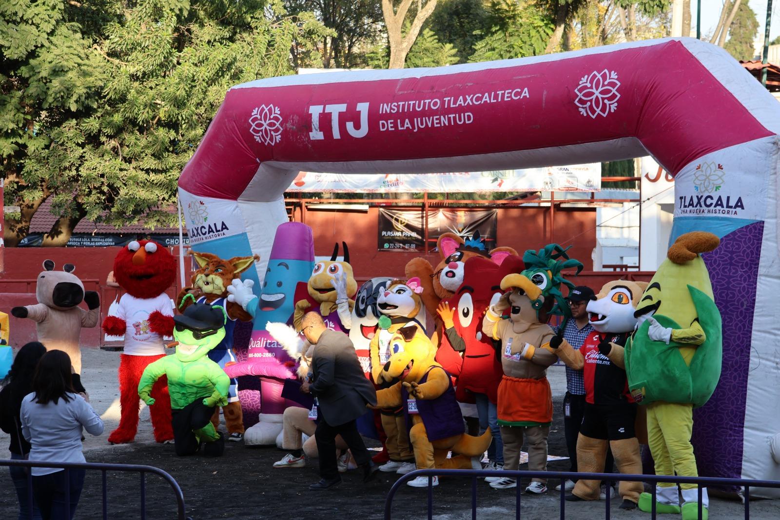 Tlaxcaltecas disfrutan de la carrera de botargas en la Feria de Tlaxcala 2025.